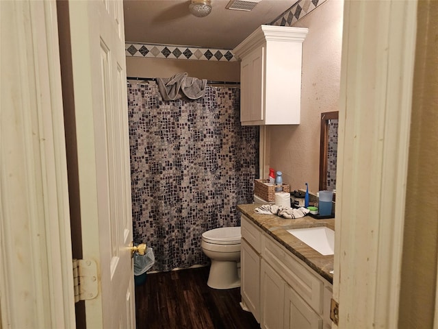 bathroom featuring toilet, vanity, and hardwood / wood-style flooring