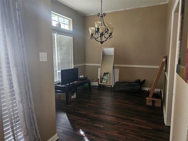 interior space with dark wood-type flooring and an inviting chandelier