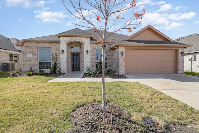 ranch-style house with a front yard, a garage, and central AC unit