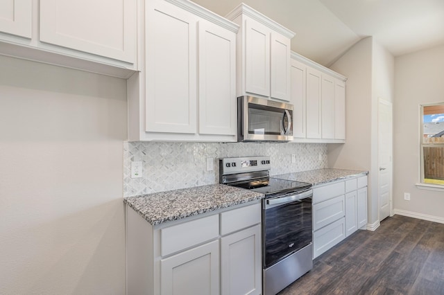 kitchen featuring decorative backsplash, light stone counters, stainless steel appliances, dark wood-type flooring, and white cabinetry