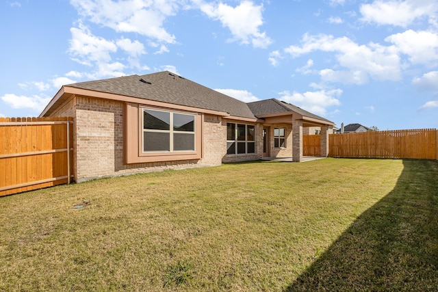 rear view of house with a lawn