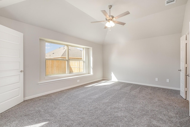 carpeted empty room featuring ceiling fan and lofted ceiling