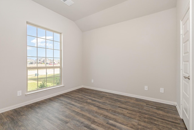 spare room with dark hardwood / wood-style flooring and lofted ceiling