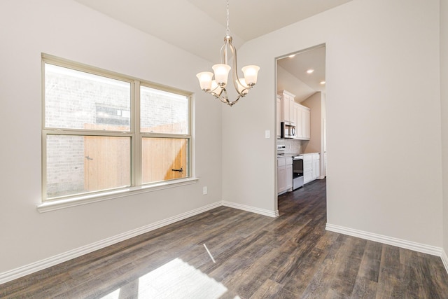 unfurnished dining area featuring dark hardwood / wood-style floors and an inviting chandelier