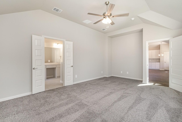 unfurnished bedroom featuring ceiling fan, light carpet, and vaulted ceiling