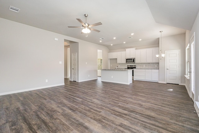 unfurnished living room with sink, vaulted ceiling, dark hardwood / wood-style floors, and ceiling fan