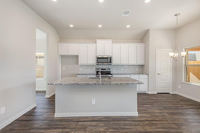 kitchen with stainless steel appliances, white cabinetry, and dark wood-type flooring