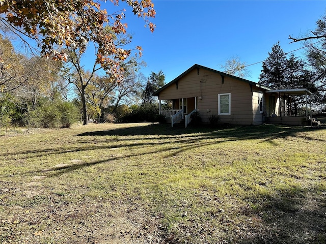 view of home's exterior featuring a yard and covered porch