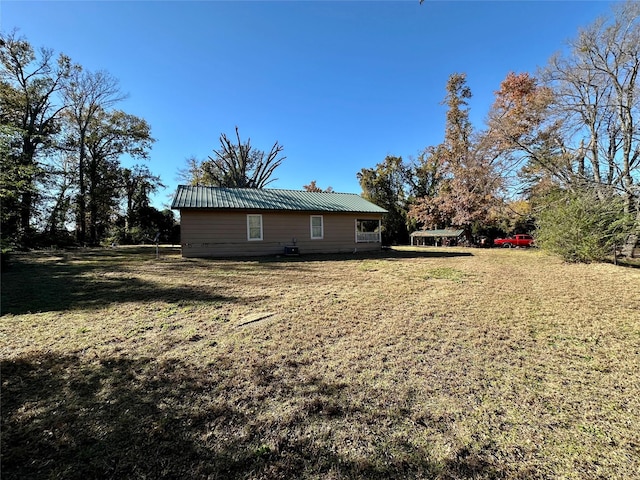 view of side of home featuring a yard