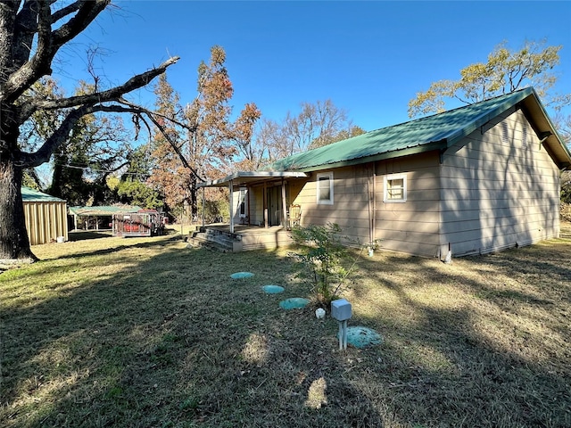 back of property featuring a yard