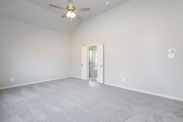 empty room with ceiling fan and high vaulted ceiling