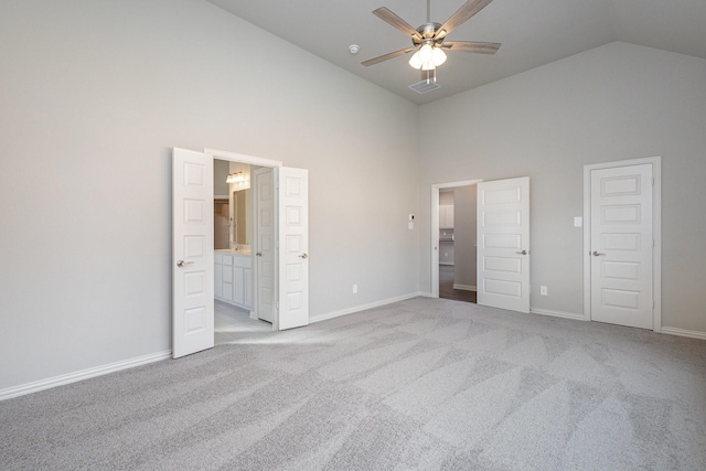 unfurnished bedroom with light colored carpet, high vaulted ceiling, and ceiling fan