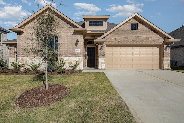 view of front of property featuring a garage and a front yard