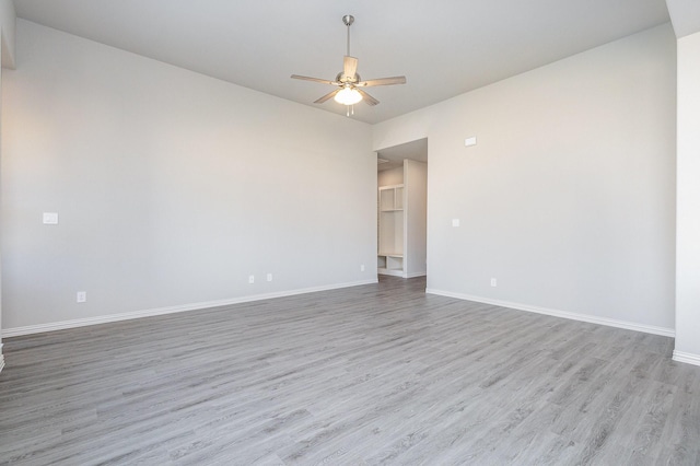 empty room with light hardwood / wood-style flooring and ceiling fan