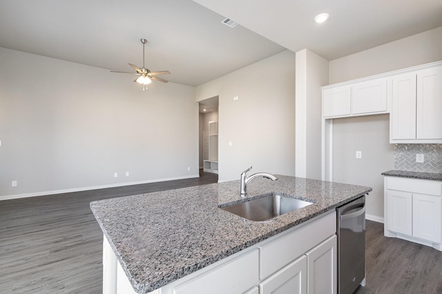 kitchen featuring an island with sink, stainless steel dishwasher, white cabinetry, and sink