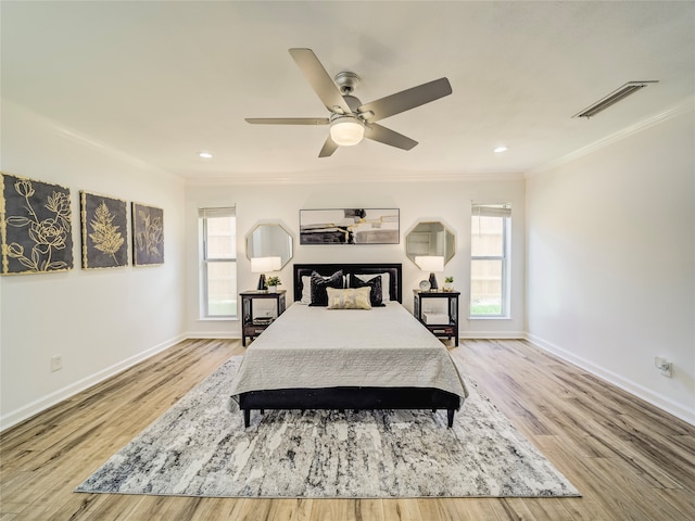 bedroom featuring ceiling fan, light wood-type flooring, and ornamental molding