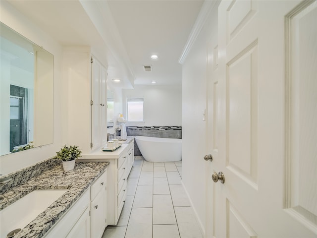 bathroom with a bathing tub, tile patterned flooring, vanity, and ornamental molding