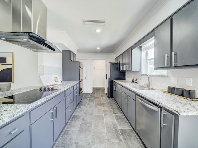 kitchen with backsplash, sink, range hood, light stone counters, and stainless steel appliances