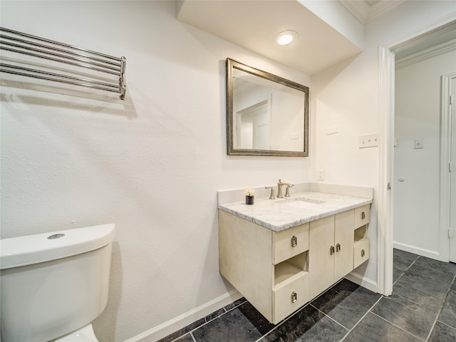 bathroom featuring tile patterned flooring, vanity, toilet, and crown molding