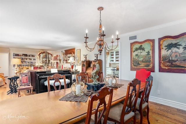 dining area with ornamental molding, wood finished floors, visible vents, and baseboards