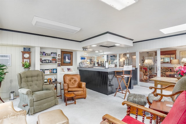 living room with ornamental molding, light carpet, a wall unit AC, and a dry bar