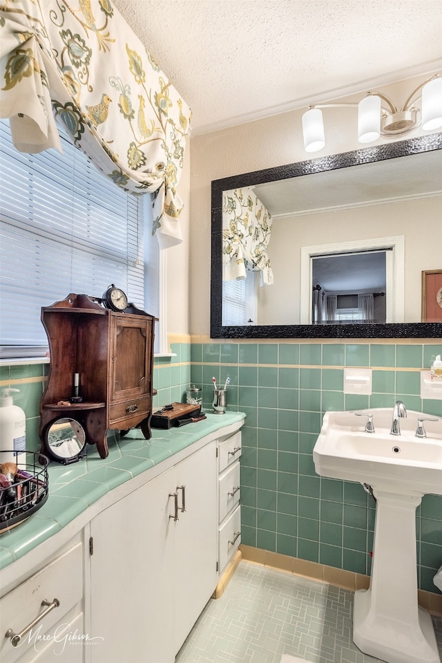 bathroom featuring tile walls, tile patterned flooring, and a textured ceiling