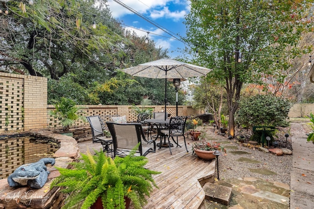 424 Monrovia St, Shreveport, LA 71106 - wooden terrace with a fenced backyard and outdoor dining area