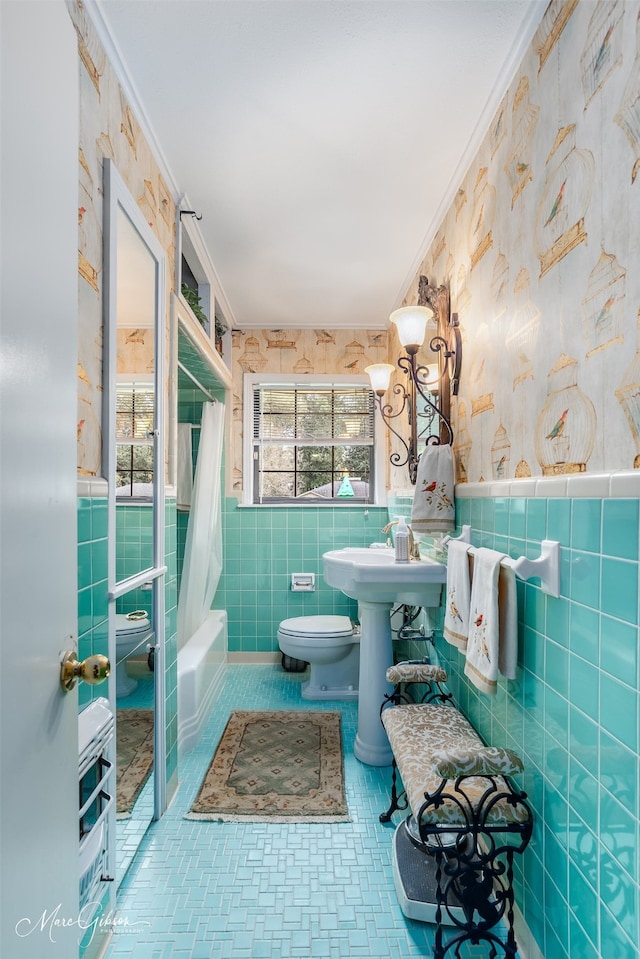 full bath with ornamental molding, shower / bath combo, tile walls, and wallpapered walls