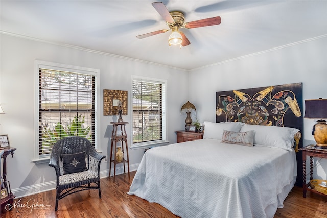 bedroom featuring ceiling fan, ornamental molding, wood finished floors, and baseboards