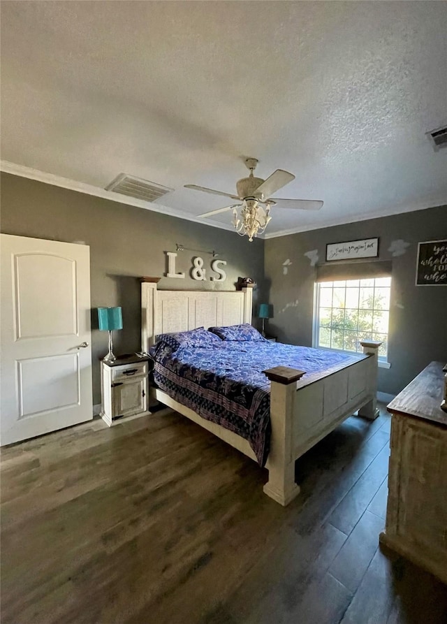 bedroom featuring ceiling fan, crown molding, dark wood-type flooring, and a textured ceiling