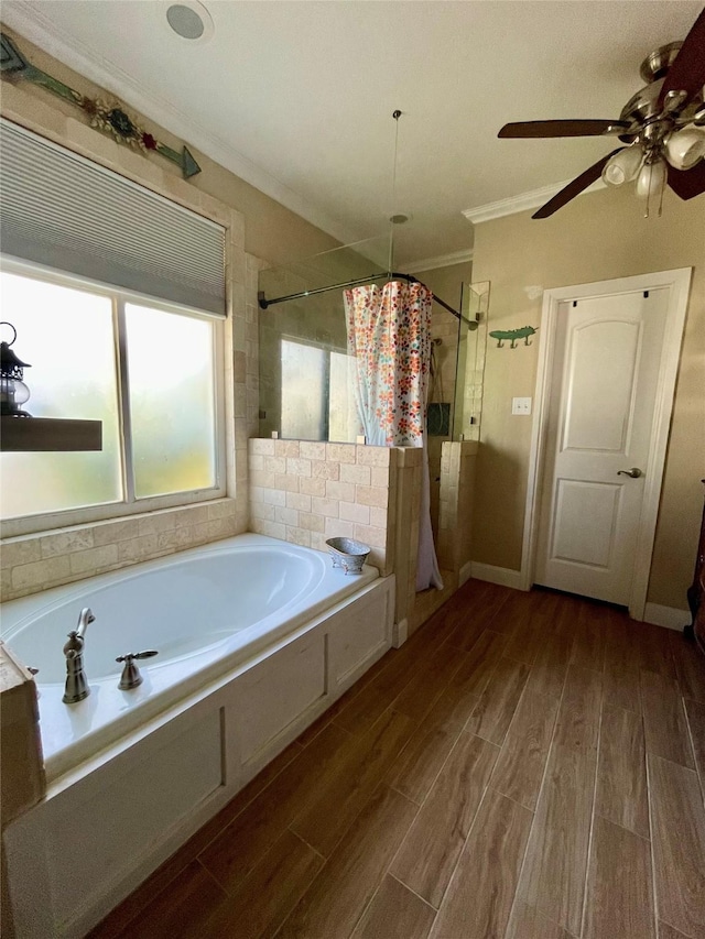 bathroom with hardwood / wood-style flooring, ceiling fan, crown molding, and independent shower and bath