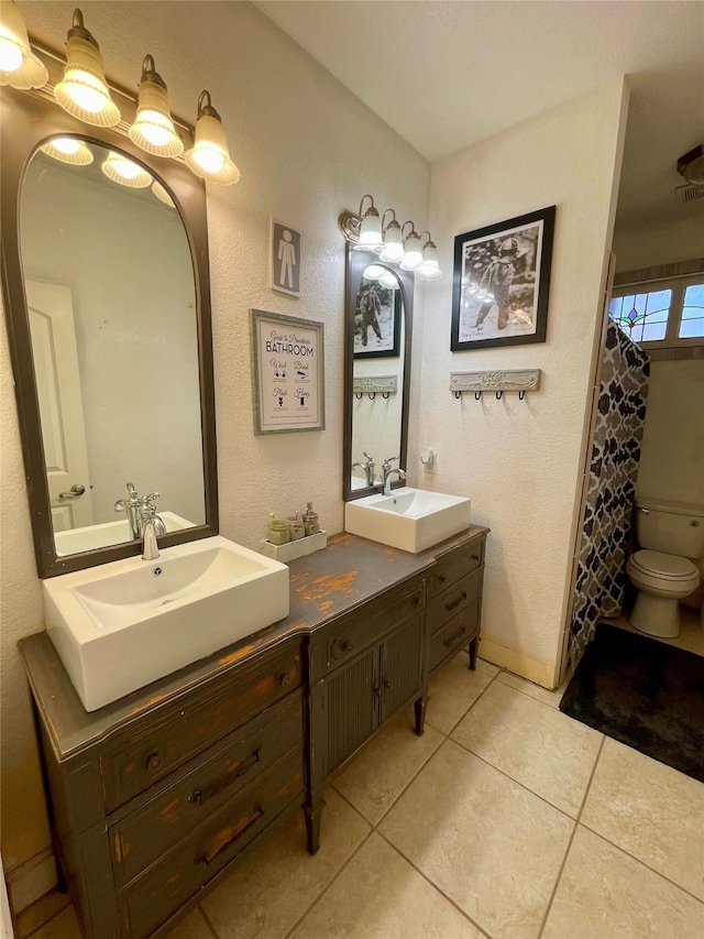 bathroom featuring walk in shower, tile patterned flooring, vanity, and toilet