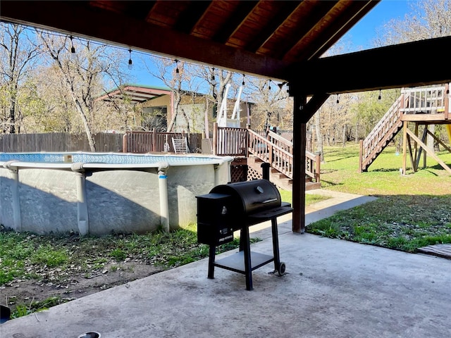 view of patio featuring a grill and a fenced in pool