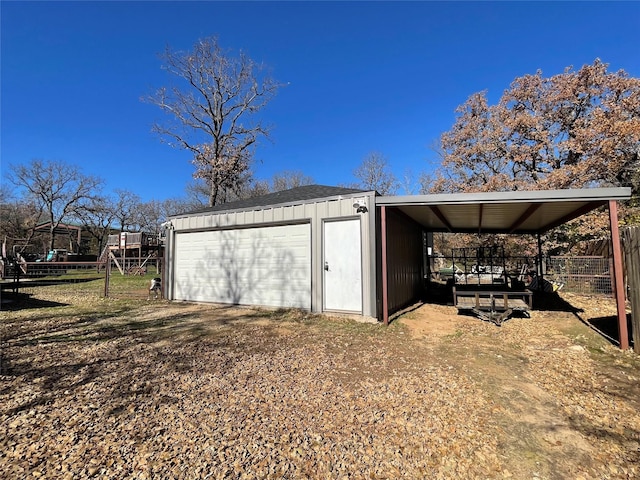 view of outbuilding with a carport and a garage