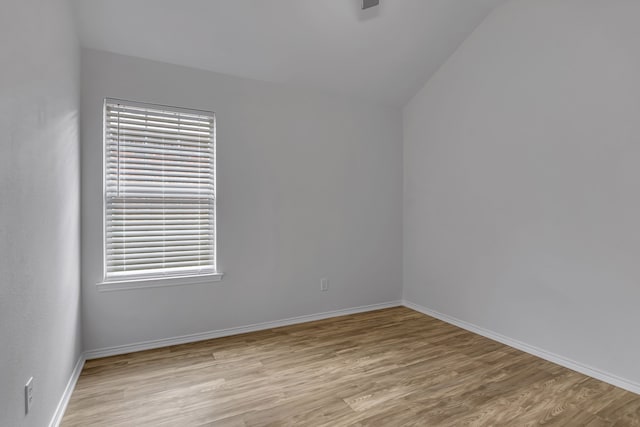 empty room featuring light wood finished floors and baseboards