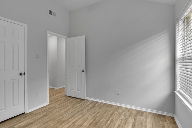 unfurnished bedroom featuring light wood-type flooring, visible vents, and baseboards