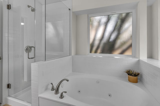 full bath featuring a stall shower and a whirlpool tub