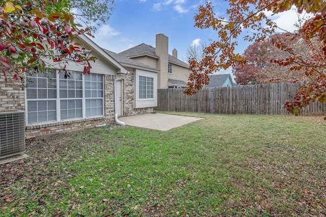 view of yard featuring a patio area, a fenced backyard, and central air condition unit