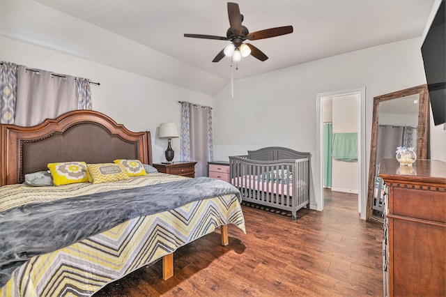 bedroom featuring lofted ceiling, ensuite bath, ceiling fan, and dark hardwood / wood-style floors