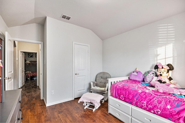 bedroom featuring dark hardwood / wood-style flooring and lofted ceiling