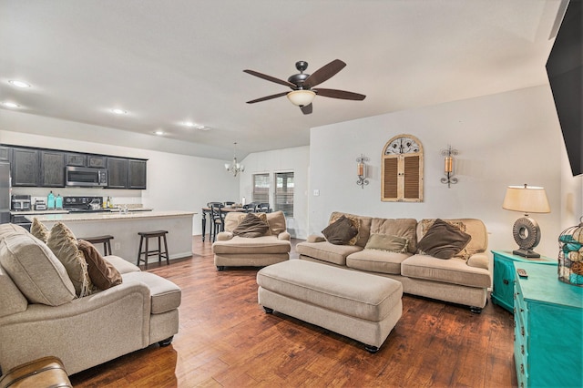 living room featuring ceiling fan with notable chandelier and dark hardwood / wood-style flooring