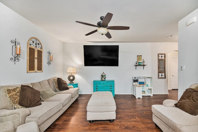 living room featuring ceiling fan and dark hardwood / wood-style flooring