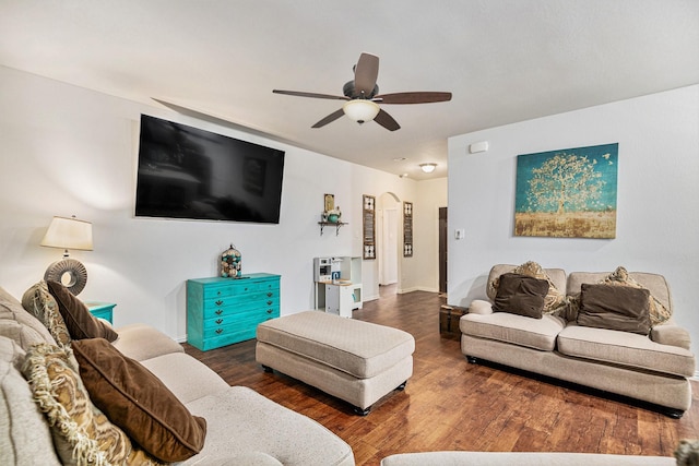 living room featuring ceiling fan and dark wood-type flooring