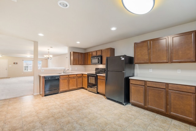 kitchen with pendant lighting, black appliances, sink, light colored carpet, and a chandelier