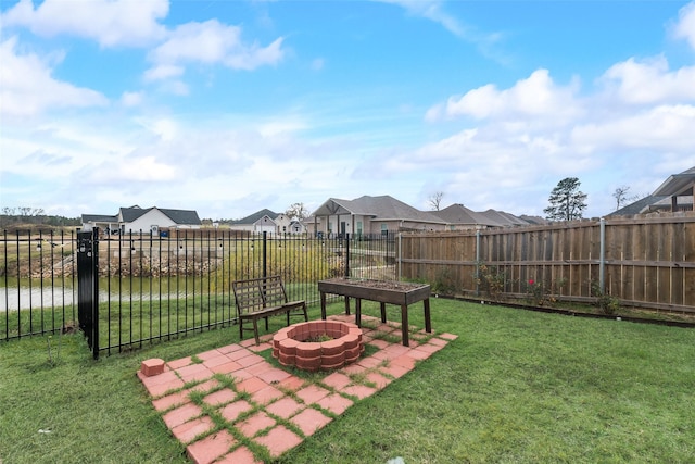 view of yard featuring a water view and a fire pit