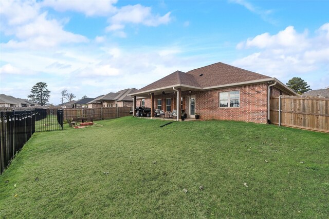 back of house featuring a lawn, a patio area, and ceiling fan