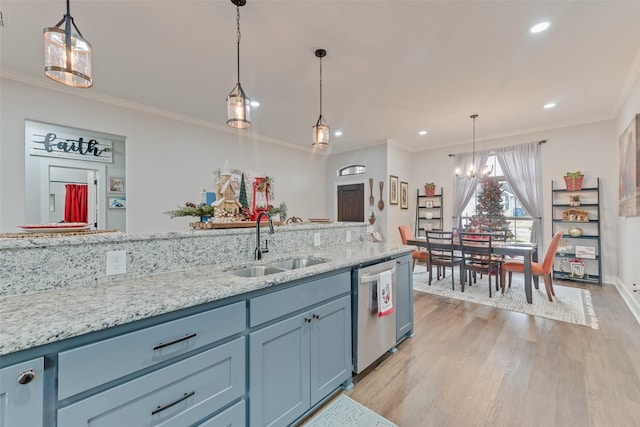 kitchen with sink, stainless steel dishwasher, decorative light fixtures, and light hardwood / wood-style floors