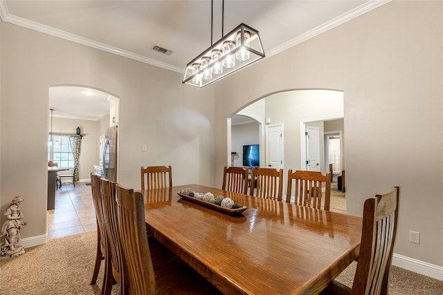 dining space with carpet floors and ornamental molding