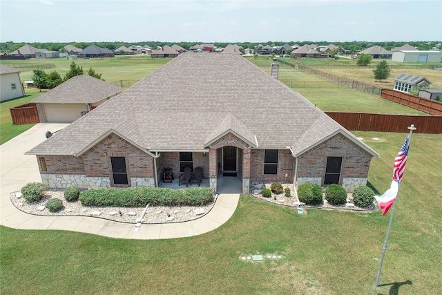 view of front facade featuring a patio and a front lawn