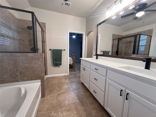 bathroom with ceiling fan, tile patterned flooring, lofted ceiling, vanity, and independent shower and bath